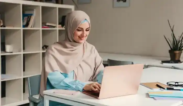 A university student in Dubai managing a busy assignment deadline and academic workload