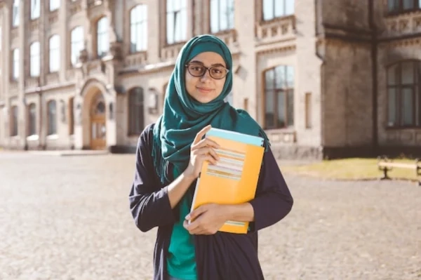 Student using assignment writing help in Ajman while checking the correct referencing style required for an Ajman University assignment.