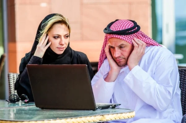 Postgraduate student using dissertation writing help in Ajman while reviewing taught phase grade requirements and academic progression guidelines.