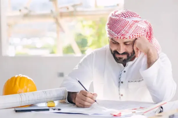 A university student in Dubai receiving academic support with an engineering report