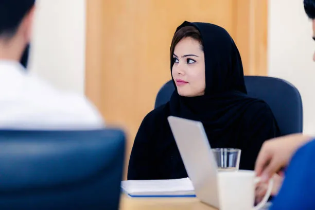 Student using essay writing help in Abu Dhabi while reviewing university grade threshold requirements for academic progression.