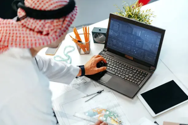 A university engineering student in Dubai reviewing IEEE references for an engineering report