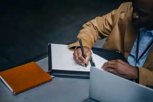 University student preparing a portfolio with visual design work in Sharjah