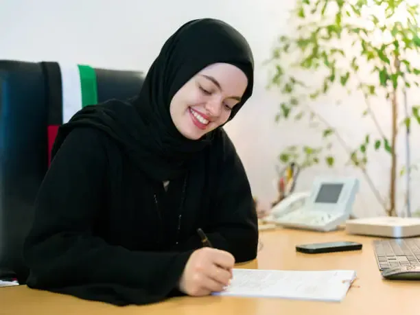 A recent graduate in Dubai reviewing a resume that highlights education and skills instead of work experience