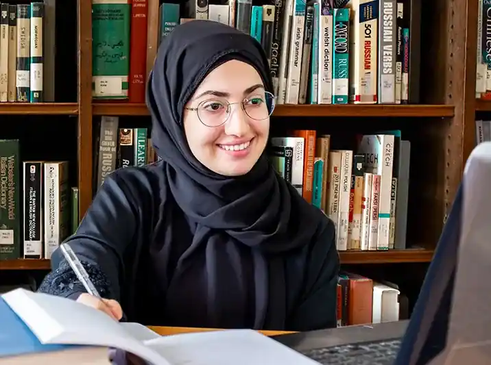 Professional academic researcher working on a university thesis with thesis writing help in Abu Dhabi.