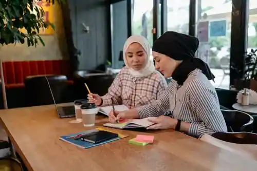 Postgraduate student using thesis writing help in Sharjah while reviewing examiner feedback after an unsuccessful thesis defense.