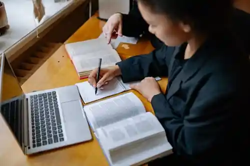 Professional academic researcher working on a university thesis with thesis writing help in Sharjah.